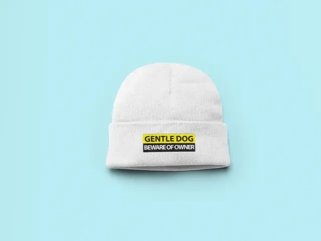 White beanie printed with a funny dog-owner quote
